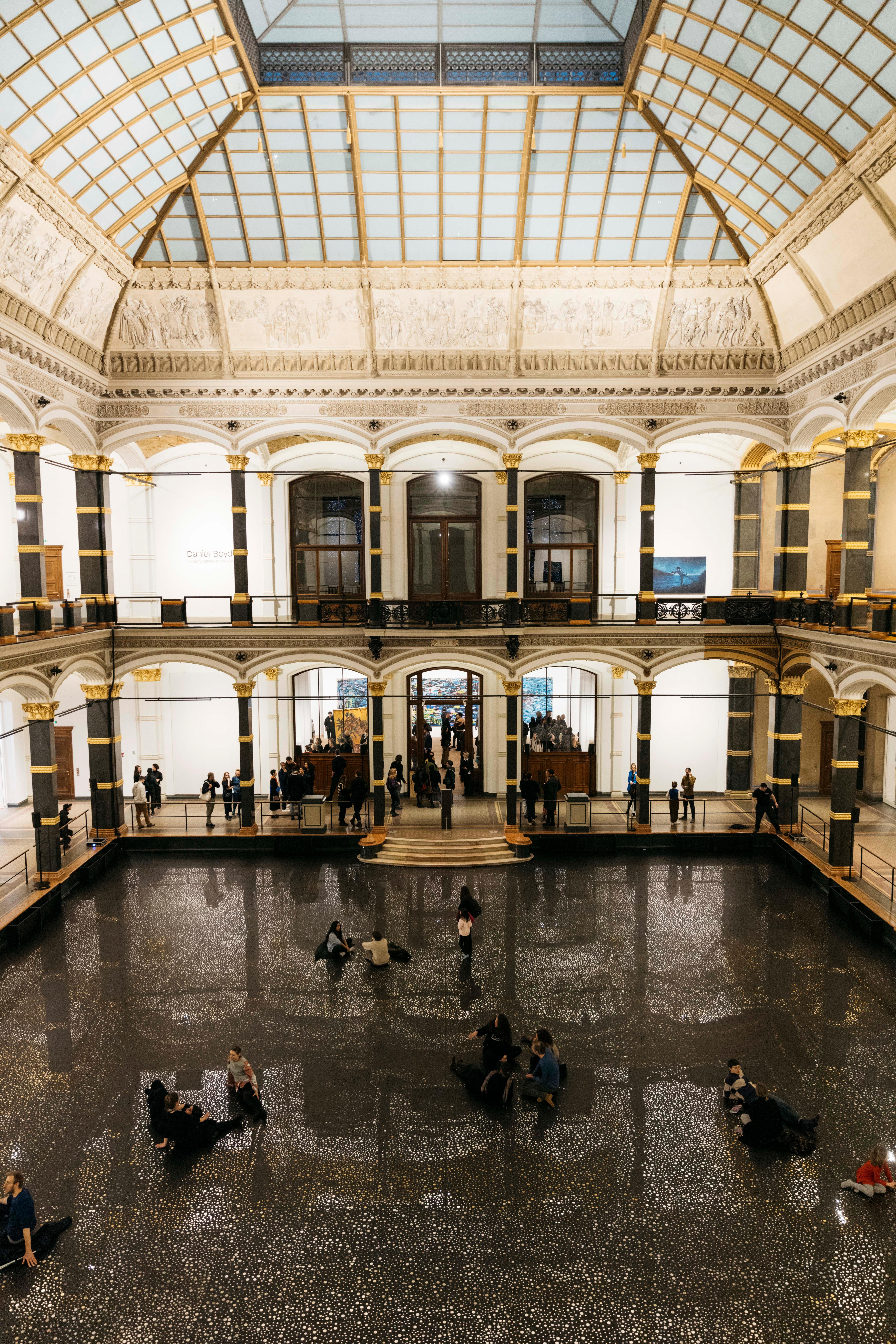The atrium of the Gropius Bau. The floor is covered with a reflective foil as part of the Daniel Boyd's exhibition "RAINBOW SERPENT (VERSION)".