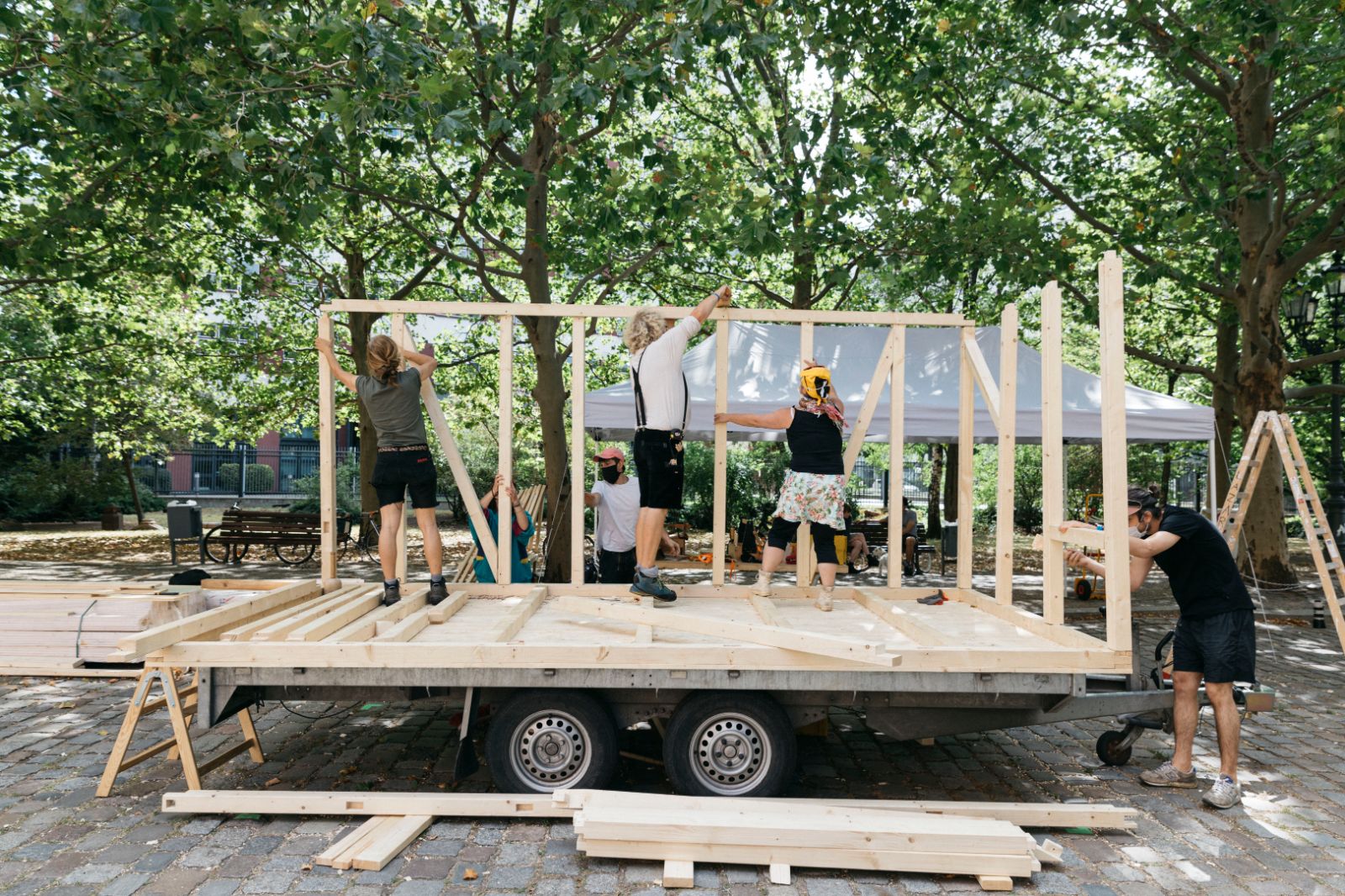 Auf einem Wagen wird eine Konstruktion aus Holz gebaut.